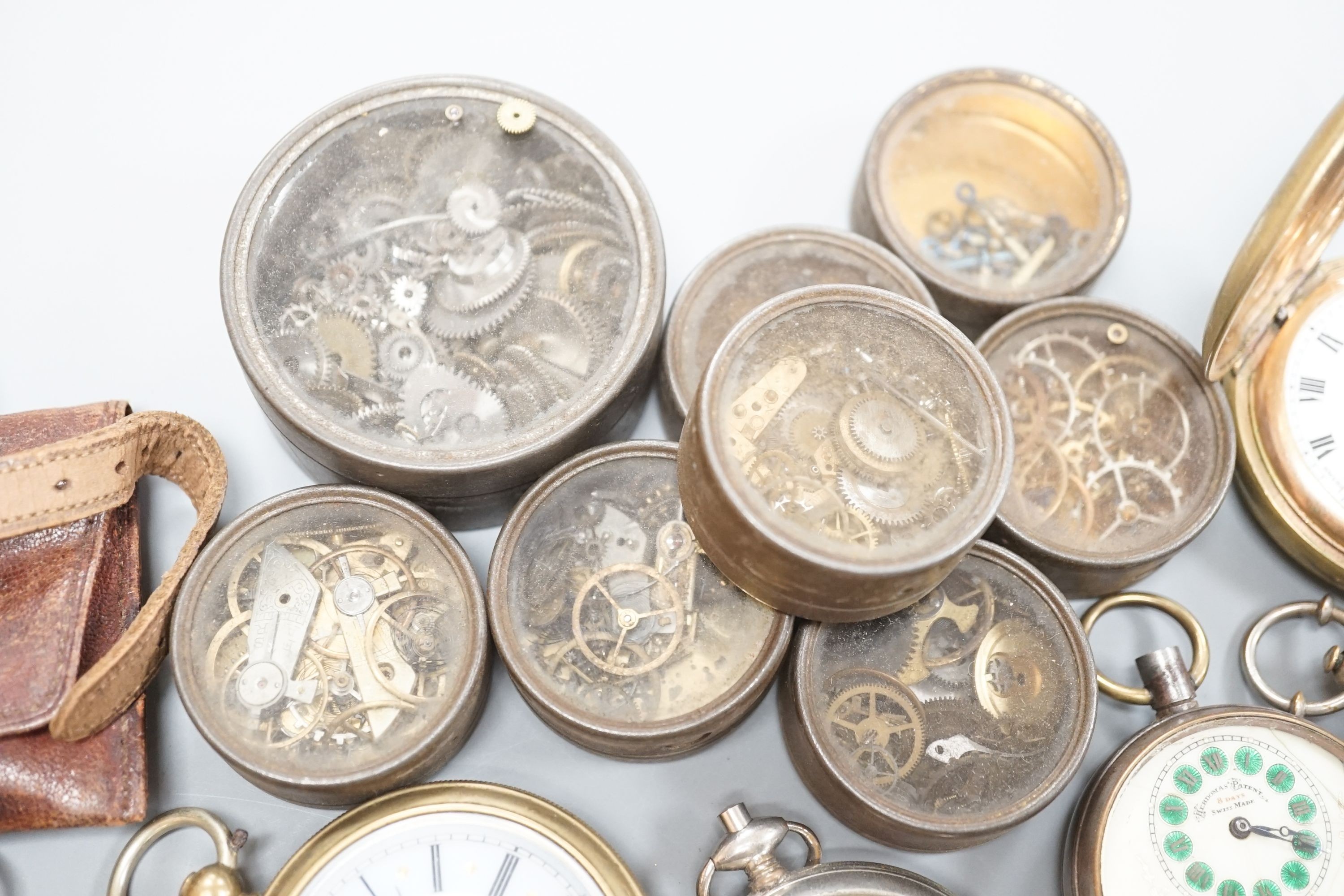 A small collection of assorted base metal and gold plated pocket watches including Hebdomas and Waltham and a small quantity of watch parts.